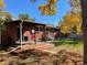 Brick patio with pergola, table, chairs, and access to grassy backyard at 12484 E Alaska Ave, Aurora, CO 80012