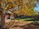 Fall foliage and a large backyard with a deck at 12484 E Alaska Ave, Aurora, CO 80012