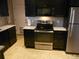 Modern kitchen with stainless steel appliances and dark wood cabinets at 12484 E Alaska Ave, Aurora, CO 80012