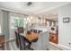 Elegant dining room with a spacious table and modern light fixture at 11022 E Fair Cir, Englewood, CO 80111