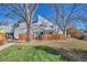 Gray townhouse exterior with wooden fence and landscaping at 2557 S Dover St # 68, Lakewood, CO 80227