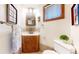 Small bathroom with corner vanity, toilet and medicine cabinet at 1233 Sunset St, Longmont, CO 80501