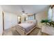 Bright bedroom with a light wooden frame bed and ensuite bathroom at 1233 Sunset St, Longmont, CO 80501