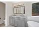 Bathroom with double vanity and a large mirror at 8782 Troon Village Pl, Lone Tree, CO 80124