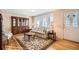 Living room featuring hardwood floors, sofa, and a charming window at 8341 Mason Cir, Westminster, CO 80031