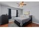 Spacious bedroom with a ceiling fan, dresser, and large bed at 1223 S Wheeling Way, Aurora, CO 80012