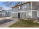 Exterior view of the townhome showcasing gray siding and landscaping at 1223 S Wheeling Way, Aurora, CO 80012
