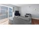Living room with gray sectional and access to balcony at 1223 S Wheeling Way, Aurora, CO 80012