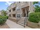 Exterior view of condo building with landscaping and walkway at 5765 W Atlantic Pl # 104, Lakewood, CO 80227