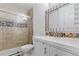 Modern bathroom with white vanity, a glass shower, and pebble tile accents at 5765 W Atlantic Pl # 104, Lakewood, CO 80227