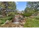 Community amenity featuring a serene waterfall and landscaping at 5765 W Atlantic Pl # 104, Lakewood, CO 80227