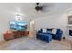 Living room with blue sofa, large TV, and access to other rooms at 5765 W Atlantic Pl # 104, Lakewood, CO 80227