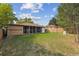 View of home's back and spacious backyard at 7886 Cyd Dr, Denver, CO 80221