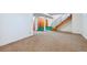 Unfinished basement area with carpeted floors and staircase at 7886 Cyd Dr, Denver, CO 80221