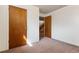 Small basement bedroom with wood doors and access to the stairs at 7886 Cyd Dr, Denver, CO 80221