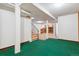 View of a carpeted basement with staircase and partial view of the living area at 7886 Cyd Dr, Denver, CO 80221