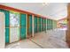 Covered carport with teal corrugated metal walls at 7886 Cyd Dr, Denver, CO 80221