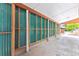 Long carport with teal corrugated metal siding at 7886 Cyd Dr, Denver, CO 80221
