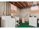 Basement laundry room with washer, dryer, and utility sink at 7886 Cyd Dr, Denver, CO 80221