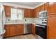 Kitchen boasts wood cabinets, stainless steel appliances, and light flooring at 7886 Cyd Dr, Denver, CO 80221