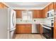 Stainless steel appliances and wood cabinets in this kitchen at 7886 Cyd Dr, Denver, CO 80221