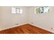 Well-lit bedroom with hardwood floors and ample closet space at 7886 Cyd Dr, Denver, CO 80221