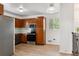 Kitchen with wood cabinets, stainless steel appliances, and light flooring at 7886 Cyd Dr, Denver, CO 80221
