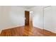 Bedroom with hardwood floors and access to another room at 7886 Cyd Dr, Denver, CO 80221