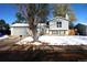 Two story home with attached garage and snow covered yard at 17413 E Louisiana Ave, Aurora, CO 80017