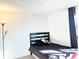 Bedroom with a black headboard and gray bedding at 17413 E Louisiana Ave, Aurora, CO 80017