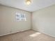 Well-lit bedroom with neutral walls and carpet at 1250 S Monaco Pkwy # 2, Denver, CO 80224