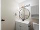 Updated bathroom with a vanity and a round mirror at 1250 S Monaco Pkwy # 2, Denver, CO 80224
