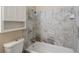 Clean bathroom with bathtub and neutral tile at 1250 S Monaco Pkwy # 2, Denver, CO 80224