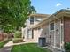 Tan two-story building exterior with private entrance and landscaping at 1250 S Monaco Pkwy # 2, Denver, CO 80224