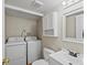 Convenient laundry area with washer, dryer, and storage cabinet at 1250 S Monaco Pkwy # 2, Denver, CO 80224