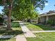 Residential community with a grassy yard and tree-lined walkways at 1250 S Monaco Pkwy # 2, Denver, CO 80224