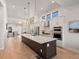 Open concept kitchen with island, stainless steel appliances and hardwood floors at 3907 Piney Grove St, Evergreen, CO 80439