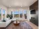 Spacious living room with large windows, fireplace, and mountain views at 3907 Piney Grove St, Evergreen, CO 80439