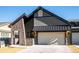 Modern home with stone accents and attached two-car garage at 3907 Piney Grove St, Evergreen, CO 80439