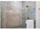 Elegant shower with marble tile and gold fixtures at 3907 Piney Grove St, Evergreen, CO 80439