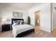 Bright bedroom with ensuite bathroom and hardwood floors at 3907 Piney Grove St, Evergreen, CO 80439