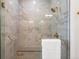 Large walk-in shower with marble tile and brass fixtures at 3907 Piney Grove St, Evergreen, CO 80439