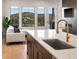Modern kitchen with island, sink, and mountain views from the window at 3907 Piney Grove St, Evergreen, CO 80439