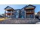 Gray two-story home with balconies and stone retaining wall at 3907 Piney Grove St, Evergreen, CO 80439