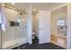 Elegant bathroom with marble shower and black tile floors at 2523 S Xavier St, Denver, CO 80219