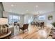 Open concept dining area with hardwood floors and a modern light fixture at 2523 S Xavier St, Denver, CO 80219