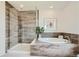 Spa-like bathroom with a large walk-in shower and soaking tub at 1756 Morgan Dr, Erie, CO 80516