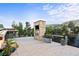 Relaxing rooftop patio with a stone fireplace, planters, and mountain views at 5123 Quaker St, Golden, CO 80403