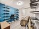 Basement office with blue walls and ample shelving at 6573 Iris St, Arvada, CO 80004