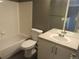 Bathroom with a bathtub, toilet, sink, and white vanity at 137 S Syracuse St, Denver, CO 80230